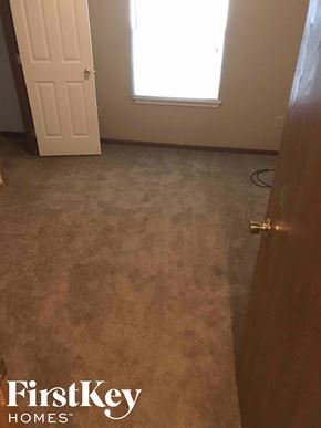 Noblesville house for rent - A room with a carpeted floor and a door.