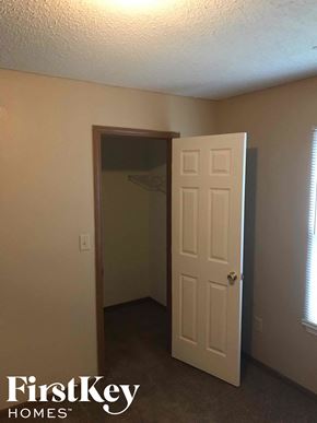 Noblesville house for rent - A room with a white door and a window with blinds.
