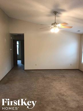 Noblesville house for rent - A room with a ceiling fan and a door.