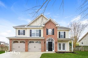 Clemmons house for rent - A two-story house with a brick facade and a large front yard.