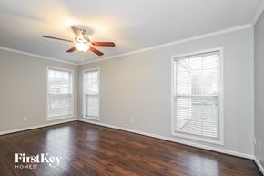 Clemmons house for rent - A room with a ceiling fan and wooden floors.