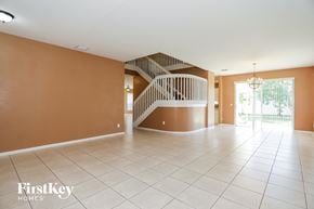 Miramar house for rent - an empty living room with a staircase in the center of it