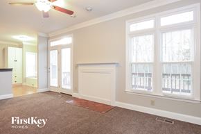 Kernersville house for rent - A room with a fan, carpet and a window.