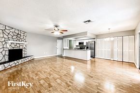 Palm Harbor house for rent - an empty living room with a fireplace and a kitchen