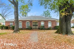 Memphis house for rent - a brick house with two trees in front of it