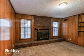 Memphis house for rent - the living room of a house with a brick fireplace