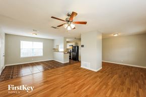 San Antonio house for rent - A spacious room with wooden floors and a ceiling fan.