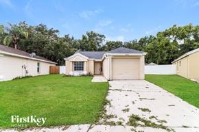 Brandon house for rent - a home with a lawn and a garage door