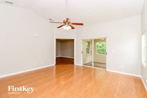 Brandon house for rent - the living room and dining room with wood floors and a ceiling fan