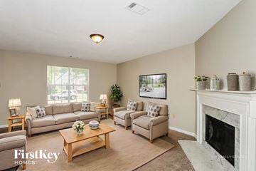 Memphis house for rent - A living room with a fireplace and a painting on the wall.