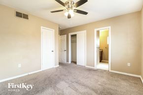 Mesa house for rent - A spacious room with a ceiling fan and beige walls.