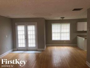 Lawrenceville house for rent - A room with wooden floors and a window with blinds.