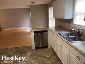 Lawrenceville house for rent - A kitchen with a sink, dishwasher, and cabinets.