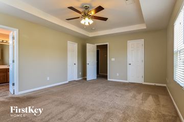 Kernersville house for rent - a living room with carpet and a ceiling fan