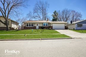 Elgin house for rent - a home with a lawn and a white garage door