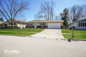 Elgin house for rent - a home with a driveway and a white garage door