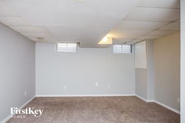 Elgin house for rent - the living room of an apartment with carpet and white walls