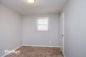 Elgin house for rent - a bedroom with white walls and carpet and a window