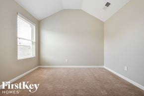 Mcdonough house for rent - a bedroom with a carpeted floor and a window