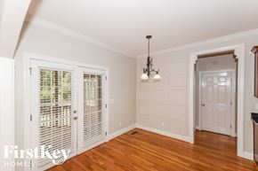 Bessemer house for rent - A room with wooden floors and a chandelier hanging from the ceiling.