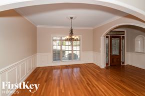 Bessemer house for rent - A room with wooden floors and a chandelier hanging from the ceiling.