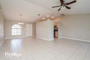 Fort Myers house for rent - an empty living room with a ceiling fan
