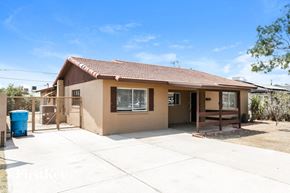 Phoenix house for rent - a small tan house with a patio and a fence