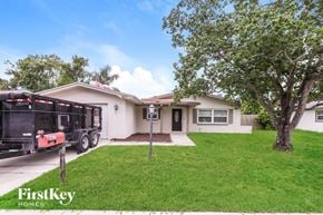 Oldsmar house for rent - A house with a tree in front of it.