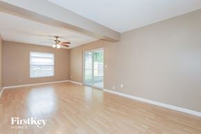Oldsmar house for rent - A spacious room with wooden flooring and a ceiling fan.