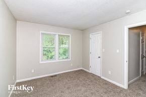 Acworth house for rent - a bedroom with carpet and a white door and window