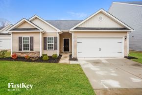 Gastonia house for rent - a white and tan house with a white garage door