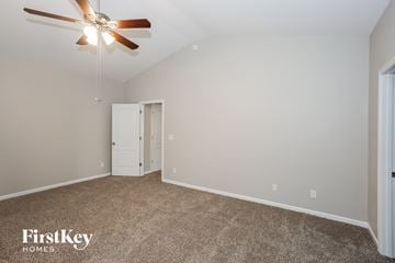 Gastonia house for rent - the spacious living room with ceiling fan and carpet