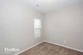 Gastonia house for rent - a bedroom with white walls and carpet and a window