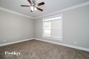 Winston-Salem house for rent - a bedroom with a ceiling fan and a window