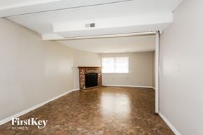 Florissant house for rent - a living room with white walls and a fireplace