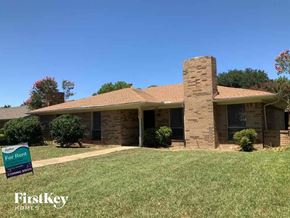 Lewisville house for rent - a brick house with a yard and a sign for hickory homes