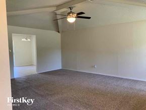 Lewisville house for rent - an empty living room with a ceiling fan