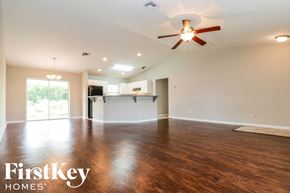 Fort Myers house for rent - A spacious room with a ceiling fan and wooden flooring.