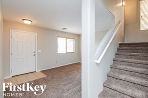 San Tan Valley house for rent - the entryway of a house with stairs and a white door