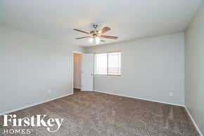San Tan Valley house for rent - a bedroom with a ceiling fan and a white door