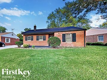Homewood house for rent - a small brick house with a yard in front of it