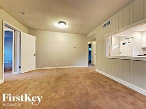 Homewood house for rent - an empty living room with carpeting and a mirror