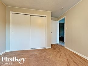 Homewood house for rent - a bedroom with white closets and a carpeted floor