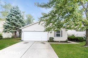 Indianapolis house for rent - a small white house with a sidewalk in front of it