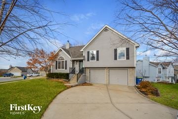 Liberty house for rent - a white house with a driveway and a garage door