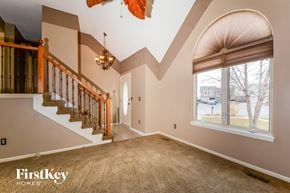 Liberty house for rent - the foyer and staircase of a house with a large window