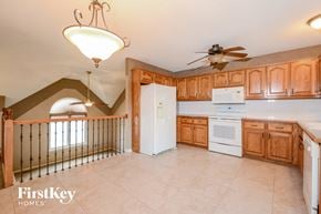 Liberty house for rent - a kitchen with white appliances and wooden cabinets