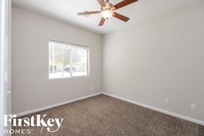 San Tan Valley house for rent - a bedroom with a ceiling fan and a window