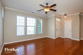 Davidson house for rent - A room with a ceiling fan and wooden floors.
