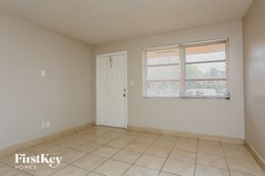 North Lauderdale house for rent - the living room of an empty house with a window and a door